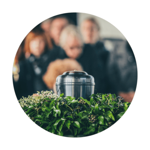 Urn surrounded by flowers at a funeral service, representing post-death doula care, grief support, and compassionate after-death guidance.